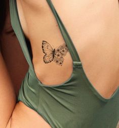 a woman with a butterfly tattoo on her back