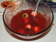 a bowl filled with liquid and fake eyes