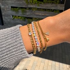 Our Diamond Tennis Bracelet has a unique look that makes it perfect for wearing alone or layering. This bracelet is made using a real 18k gold dipped stainless steel chain and cubic zirconia crystals, which makes it stand out from all the rest. A beautiful piece of jewelry made in California by women who know what they love! ✔Hypoallergenic ✔Quality Guaranteed ✔Water Resistant ✔Handmade COLOR: gold LENGTH: 6.5 inches SIZE: 4mm stones MATERIAL: Stainless steel dipped in 18k gold, cubic zirconia Stackable Cubic Zirconia Tennis Bracelet As Gift, Dainty Stackable Cubic Zirconia Bracelets, Trendy Cubic Zirconia Bangle Bracelet, Trendy Gold Diamond Jewelry, Trendy Everyday Diamond Jewelry, Gold Cubic Zirconia Stackable Tennis Bracelet, Yellow Gold Bracelets With Adjustable Chain And Cubic Zirconia, Yellow Gold Cubic Zirconia Cuban Link Bracelet For Gift, Adjustable Cubic Zirconia Chain Bracelets