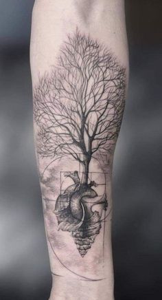 a person with a tree and heart tattoo on their arm is shown in black and white