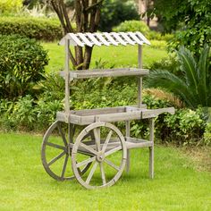 an old wooden cart sitting in the grass