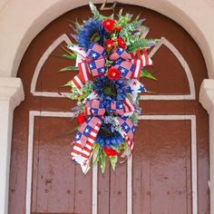 a patriotic wreath hanging from the front door