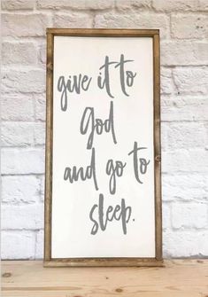 a sign that says give it to god and go to sleep on top of a shelf