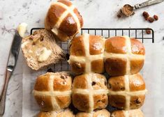 several hot cross buns on a cooling rack