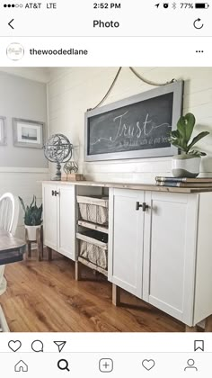 an instagram photo of a dining room with white furniture and wood flooring, including a chalkboard on the wall