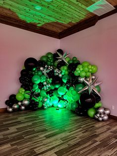 a room filled with balloons and stars on the ceiling