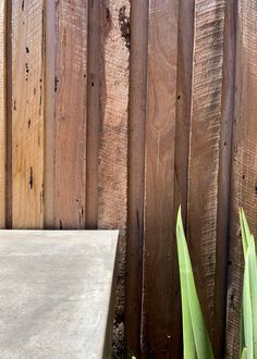 a white table sitting next to a wooden fence