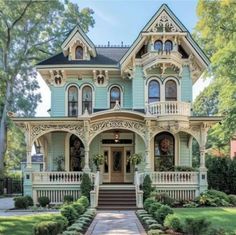 an old victorian style house with many windows and balconies on the front porch