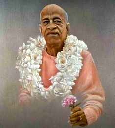 an old man with flowers in his hand and wearing a pink sweater on top of it