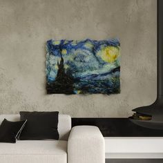 a living room with a white couch and a painting on the wall above it that looks like van gogh's starry night