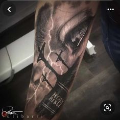 a man's arm with an eye and lightning behind it