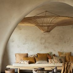 a living room filled with lots of furniture and pillows on top of a wooden table