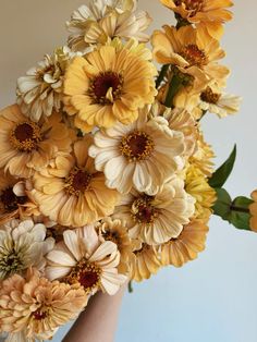 a vase filled with yellow and white flowers