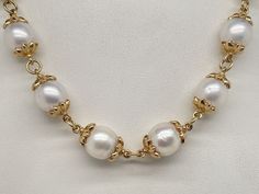 14k Yellow Gold Capped Pearl Necklace. It measures 18” long and weighs an impressive 52.6 Grams. The pearls measure around 9mm with some a little bigger. There are 22 pearls in the necklace. The lobster claw is hallmarked 14k and the pearl caps were acid tested 14k gold. A bold look fit for a queen. Formal 14k Gold Single Strand Necklace, Formal Single Strand 14k Gold Necklace, Classic 14k Gold Pearl Necklace, Luxury Round Custom Necklace For Formal Occasions, Luxury Formal Custom Round Necklace, Classic Single Strand Pearl Necklace In 14k Gold, Yellow Gold Necklace With High Luster Round Beads, Yellow Gold High Luster Round Beads Necklace, Elegant Custom Necklace With Polished Finish For Formal Occasions