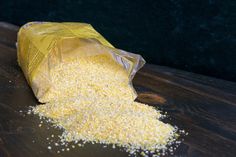 a bag of corn sitting on top of a wooden table