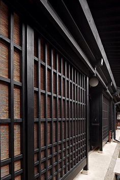 a long hallway with wooden screens on the wall