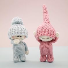 two small crocheted stuffed animals sitting next to each other