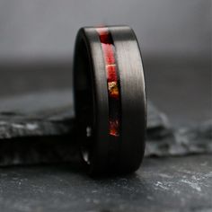 a black ring with red and yellow inlays