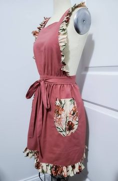 a mannequin wearing a pink dress with flowers on it