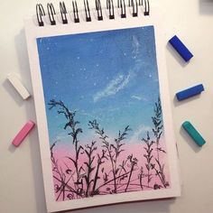 a drawing with pastel crayons on top of it