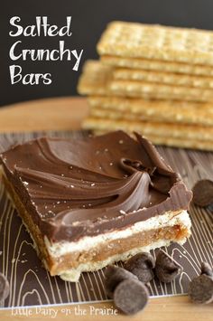 chocolate and peanut butter bar on a plate with crackers next to it that says salted crunchy bars