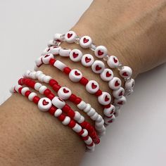 the bracelets are decorated with red and white beads