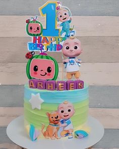 the birthday cake is decorated with cartoon characters