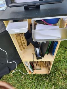 an open file cabinet on the grass with papers and files in it's drawer