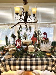 a table topped with lots of food next to a chandelier filled with lights