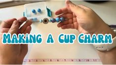 two hands are making a cup charm