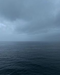 the ocean is very dark and cloudy with some clouds