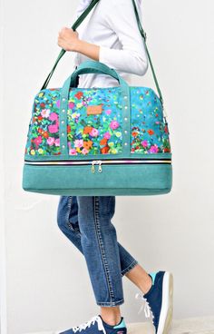 a woman carrying a handbag with flowers on it