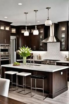 a large kitchen with dark wood cabinets and stainless steel appliances, white marble countertops