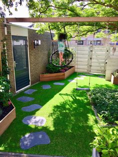 a small backyard with grass and stepping stones