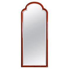 a mirror that is sitting on top of a table with a red frame around it