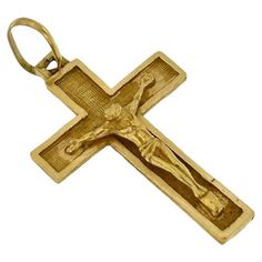 This Vintage 18-Karat Yellow Gold Crucifix is an exquisite piece of jewelry that blends traditional religious symbolism with timeless elegance. Crafted from luxurious yellow gold, this crucifix features a sophisticated satin finish that adds a subtle, refined sheen to its surface. The front of the crucifix showcases the classic form of the cross, while the back reveals a beautifully carved leaves pattern, adding an unexpected and intricate detail. This delicate carving not only enhances the overall aesthetic of the piece but also highlights the craftsmanship and attention to detail typical of vintage jewelry. The combination of the satin finish and the intricate leaf pattern carving makes this crucifix a unique and cherished item. Whether worn as a daily symbol of faith or as an elegant ac 14k Yellow Gold Crucifix Jewelry, Gold Crucifix Jewelry Collectible, Hallmarked Yellow Gold Crucifix Jewelry, Antique Yellow Gold Crucifix Jewelry, Yellow Gold Tarnish-resistant Crucifix Necklace, Slim Aarons, Leaves Pattern, Elegant Accessories, The Cross