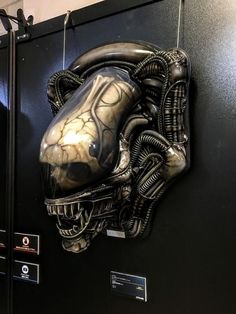 an alien head mounted to the side of a wall