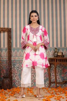 Indulge in elegance with our Pink Tie And Dye Suit Set. The beautiful pink hue and handwork make it the perfect statement piece for any occasion. Crafted from luxurious organza, the delicate tassels add a touch of charm to this unique and sophisticated ensemble. Elevate your wardrobe with this exclusive piece. No. of pieces - 2 piece set. Color - Pink. Kurta Fabric - Organza. Washing Instructions - Dry Clean.