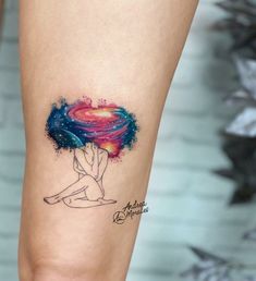 a woman's leg with a tattoo on it that has an image of a heart