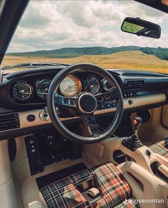 the interior of a car with plaid seats and steering wheel covers on it's dashboard