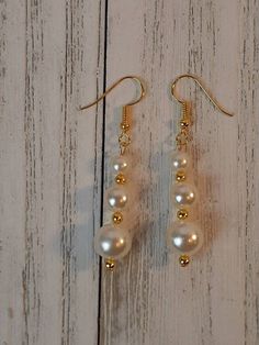 Cream Pearl and Gold Plated Dangle Drop French Wire Earrings Handmade beautiful earrings 8,6,4mm round Beads, faux pearls 3mm Gold filled beads Hypoallergenic, Nickel free, lead free, cadmium free 2 inch length 8mm width These Amazing earrings will compliment any outfit. Makes a great gift. Perfect for a wedding, prom, or special occasion or everyday wear. Packaged in a beautiful organza bag, ready for gift giving Surprise included with each order Follow my shop to see more handmade jewelry Than Handmade Pearl Earrings, French Earrings, Wire Earrings Handmade, French Wire Earrings, Stick Earrings, Handmade Jewel, Gold Dangle Earrings, Pearl Cream, Handcrafted Artisan Jewelry