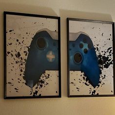 two framed video game controllers are hanging on the wall