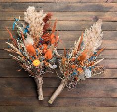 two bouquets made out of dried flowers on a wooden surface with a measuring tape in the background