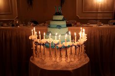 a birthday cake with lit candles sitting on top of a table