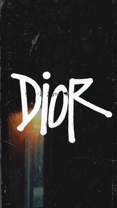 the word dior is written in white on a black background with a street light