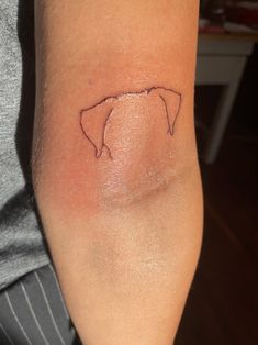 a person with a small tattoo on their arm that shows the shape of a horse's head