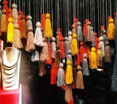 many different colored tassels hanging from the ceiling