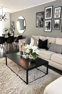 a living room filled with lots of furniture and pictures on the wall above it's coffee table