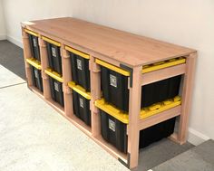 a wooden shelf with bins on top of it and yellow plastic containers in the bottom