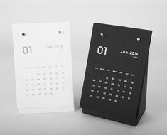 two black and white calendars sitting next to each other